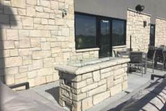 Custom linear fire pit. Stone: Cottonwood 2"-8" MSRV. Buff landscape coping.